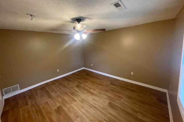 spare room featuring hardwood / wood-style floors, a textured ceiling, and ceiling fan