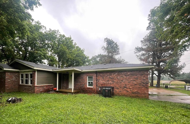 back of house with a yard and a carport