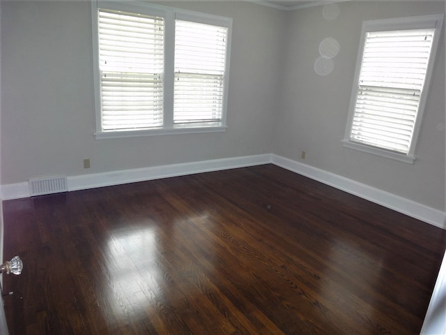 empty room with dark hardwood / wood-style flooring