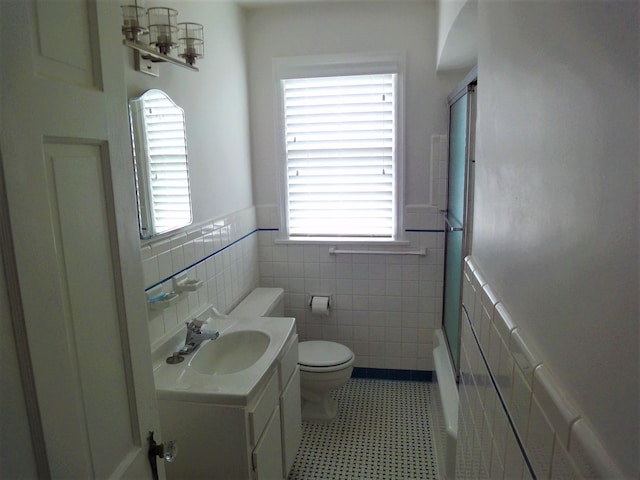 full bathroom featuring tile patterned floors, shower / bathtub combination, vanity, tile walls, and toilet