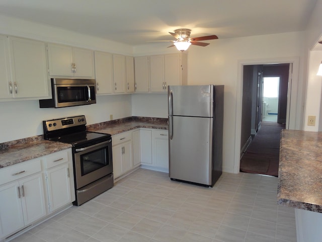 kitchen featuring white cabinets, ceiling fan, and stainless steel appliances