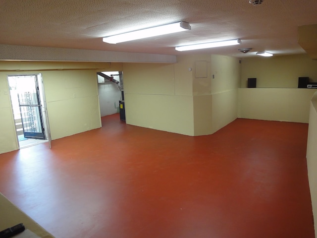 basement featuring a textured ceiling