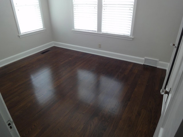 unfurnished room featuring dark wood-type flooring