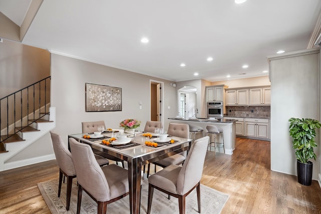 dining room featuring wood-type flooring and crown molding