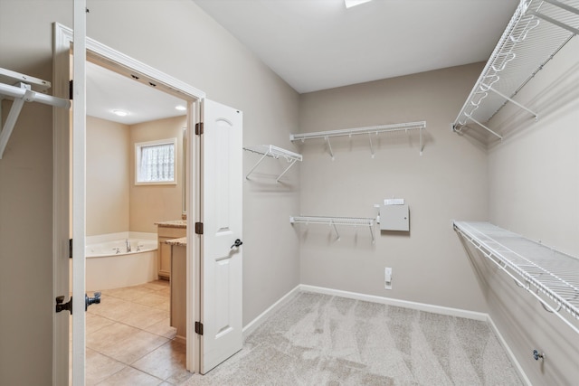 walk in closet with light tile patterned floors