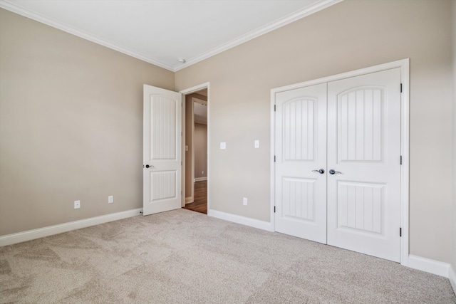 unfurnished bedroom featuring light carpet, a closet, and crown molding