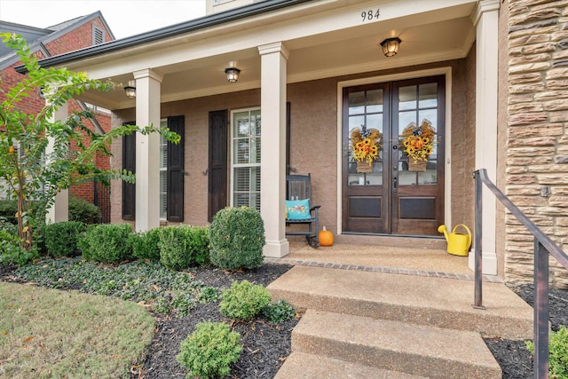 property entrance featuring a porch and french doors