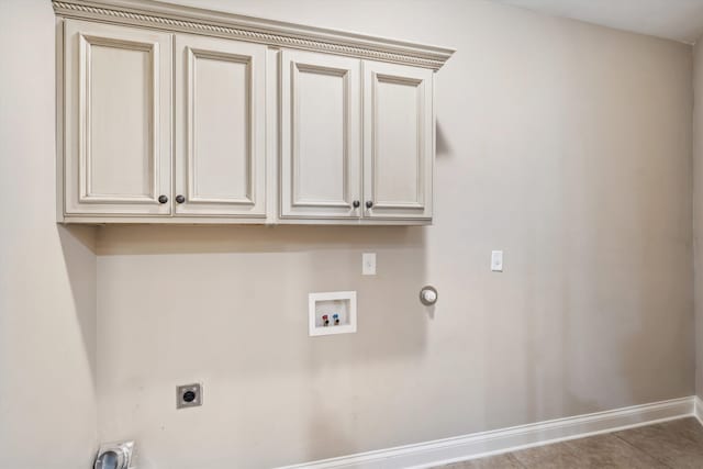 washroom featuring hookup for an electric dryer, hookup for a washing machine, tile patterned flooring, and cabinets