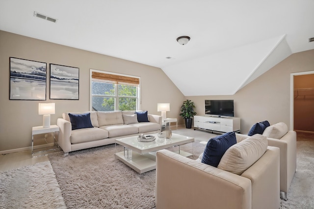 carpeted living room featuring vaulted ceiling