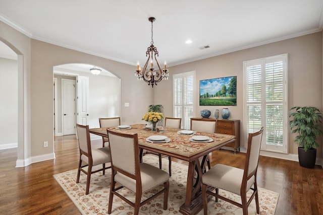 dining area featuring ornamental molding, plenty of natural light, and dark wood-type flooring