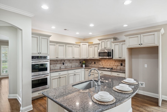 kitchen featuring crown molding, dark hardwood / wood-style flooring, sink, and appliances with stainless steel finishes