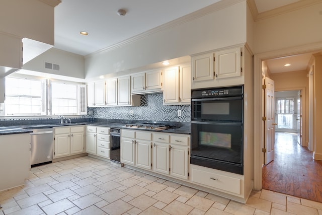 kitchen featuring tasteful backsplash, ornamental molding, a healthy amount of sunlight, and appliances with stainless steel finishes