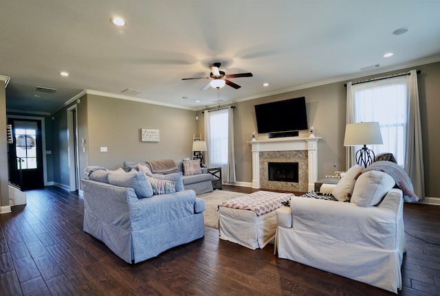 living room with a healthy amount of sunlight, dark hardwood / wood-style floors, ceiling fan, and crown molding