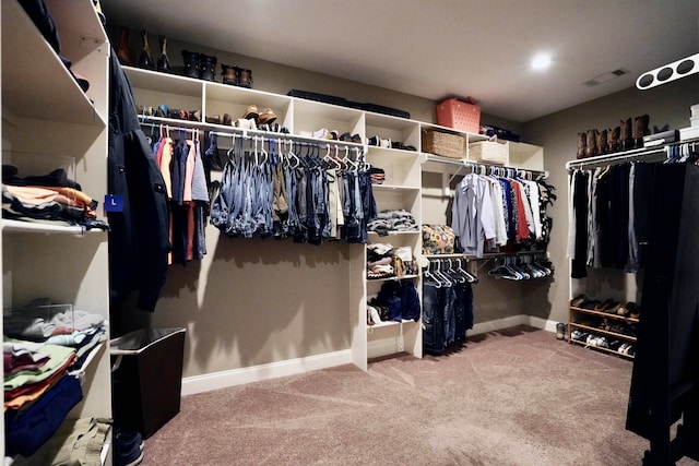 walk in closet with carpet