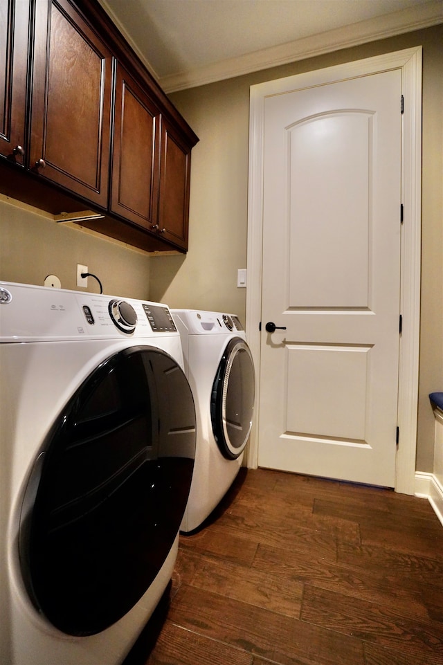 washroom featuring cabinets, dark hardwood / wood-style flooring, crown molding, and independent washer and dryer