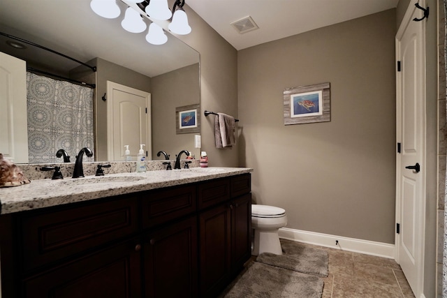 bathroom with an inviting chandelier, vanity, and toilet