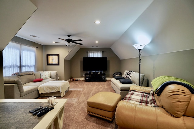 carpeted living room with ceiling fan and vaulted ceiling