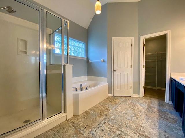 bathroom with vanity, lofted ceiling, and shower with separate bathtub