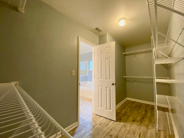 spacious closet featuring hardwood / wood-style flooring