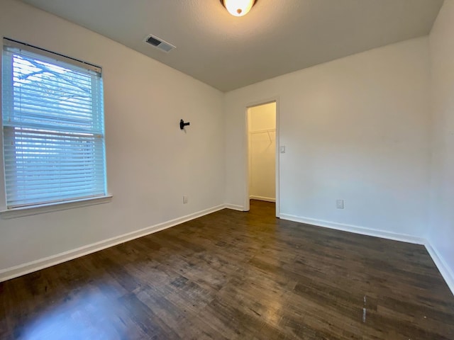 spare room featuring dark hardwood / wood-style flooring