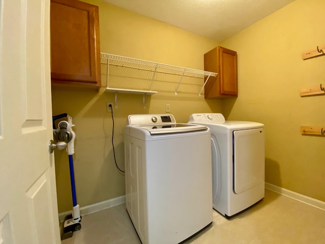 washroom featuring cabinets and independent washer and dryer