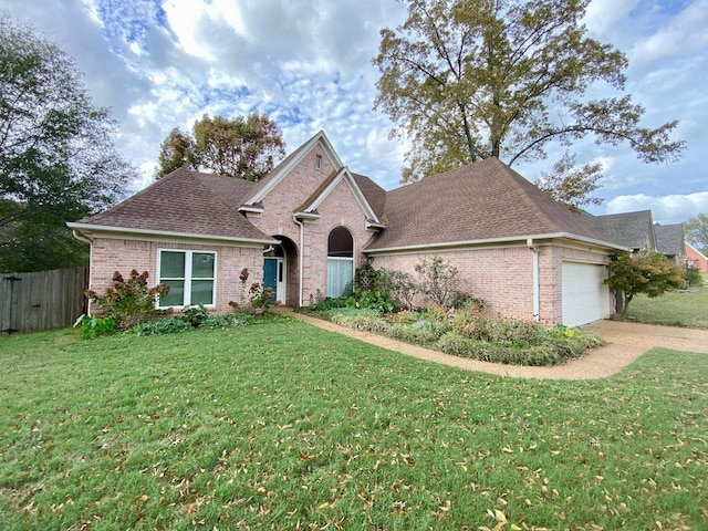 view of front of home featuring a garage and a front lawn