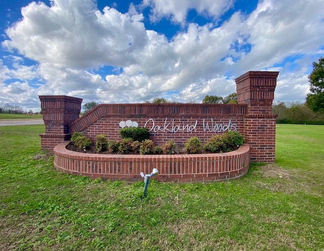 community / neighborhood sign featuring a yard