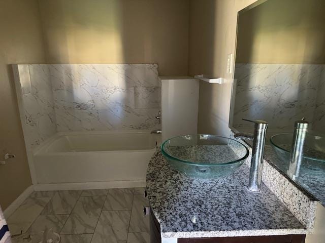 bathroom featuring a tub and vanity