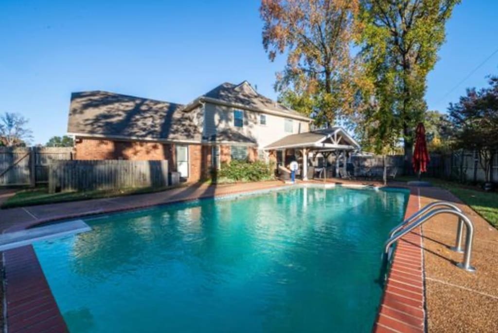 view of swimming pool with a diving board