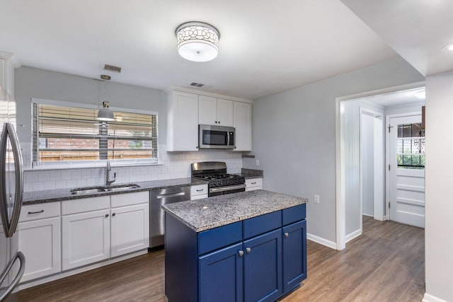 kitchen featuring white cabinets, stainless steel appliances, plenty of natural light, and sink