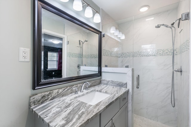 bathroom with vanity and a shower with door