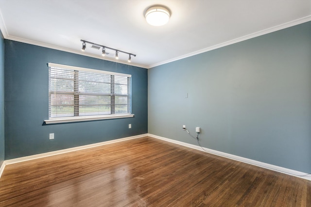 spare room with rail lighting, wood-type flooring, and ornamental molding