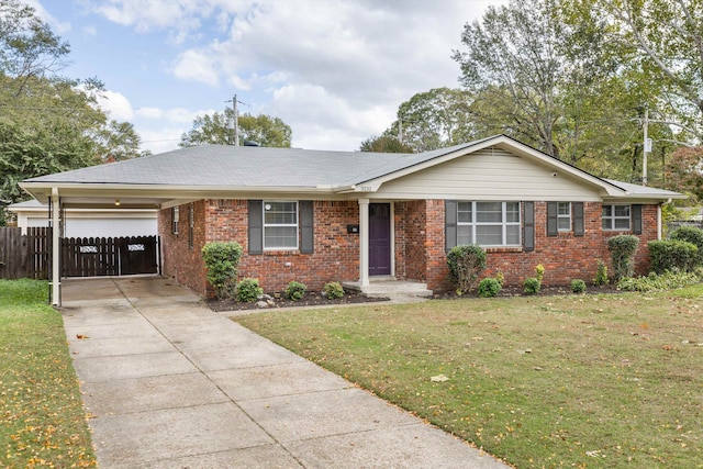 single story home with a front yard and a carport