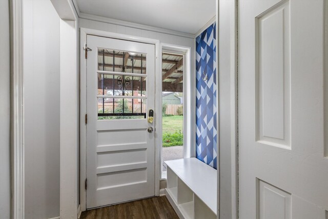 entryway featuring ornamental molding and dark wood-type flooring