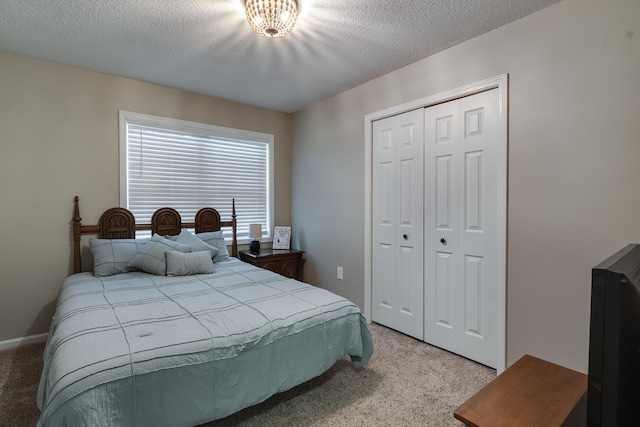 993 Greenview Rd, Collierville, TN 38017 - bedroom featuring light colored carpet, a closet, and a textured ceiling
