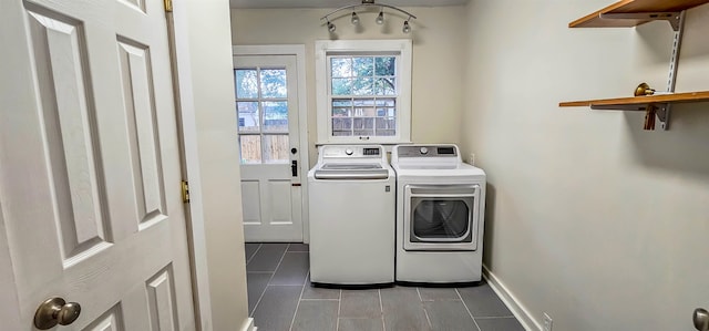 clothes washing area with washing machine and dryer