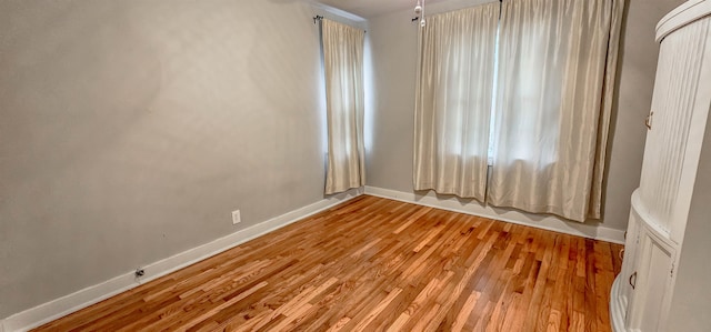 unfurnished room with light hardwood / wood-style flooring