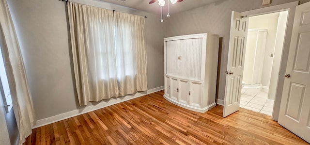 unfurnished bedroom featuring light hardwood / wood-style flooring and ceiling fan