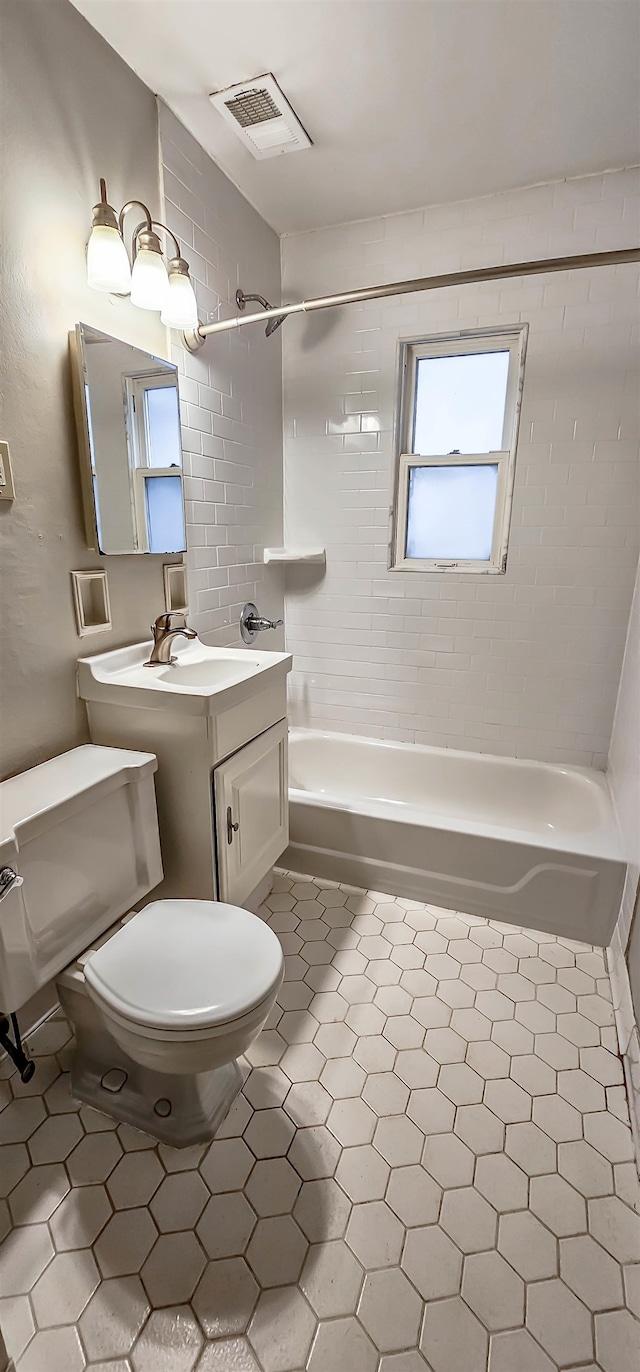 full bathroom with vanity, toilet, and tiled shower / bath