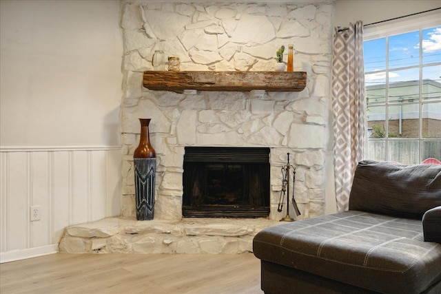 interior details with a stone fireplace and hardwood / wood-style floors