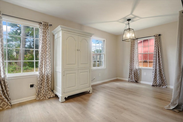 entrance foyer with light wood-type flooring and a notable chandelier