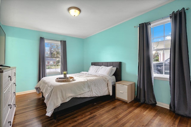 bedroom featuring crown molding and dark wood-type flooring