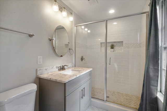 bathroom with vanity, toilet, and walk in shower