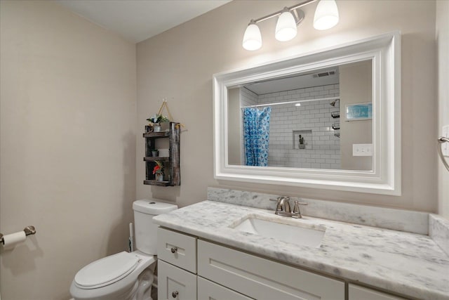 bathroom with a shower with shower curtain, vanity, and toilet