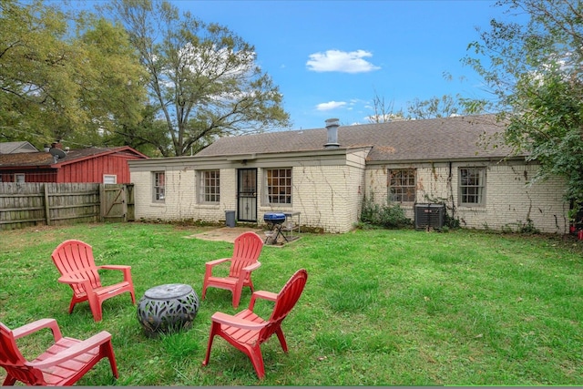 rear view of property with a lawn