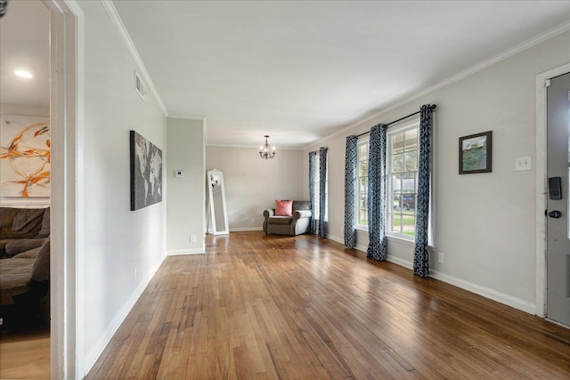 interior space with hardwood / wood-style floors, a notable chandelier, and crown molding