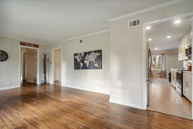 empty room featuring light hardwood / wood-style floors and crown molding