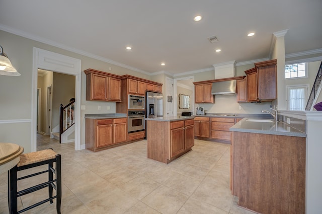 kitchen featuring sink, wall chimney exhaust hood, appliances with stainless steel finishes, a kitchen island, and ornamental molding