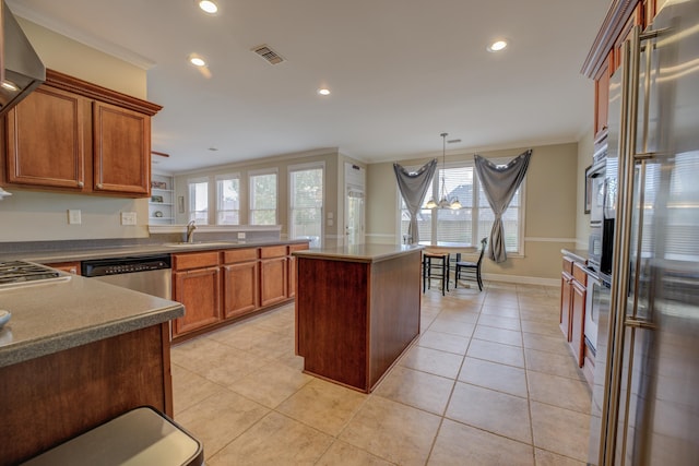 kitchen featuring a wealth of natural light, a center island, stainless steel appliances, and ornamental molding