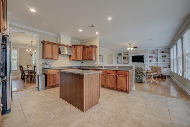 kitchen featuring ornamental molding, light hardwood / wood-style flooring, and a healthy amount of sunlight